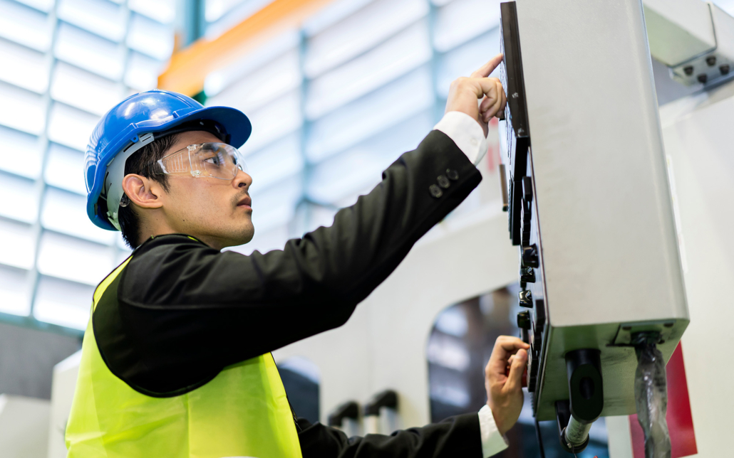 Man In Hard Hat Adjusting Building Automation Controls